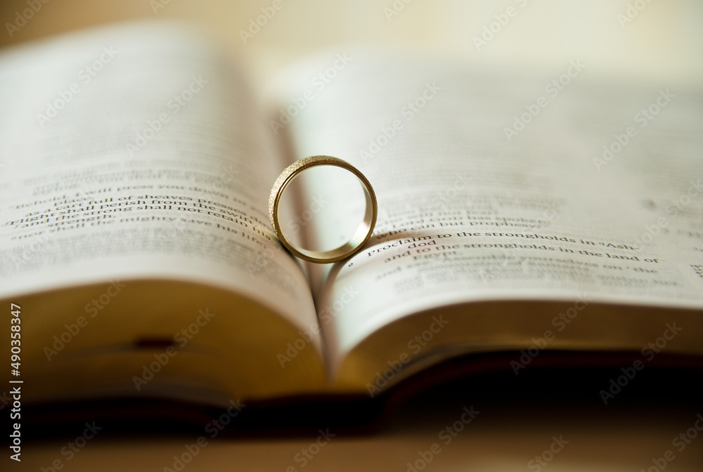 Fototapeta premium Wedding ring on a bible page.