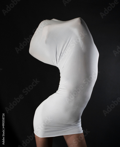 Slim woman trapped in a white skintight dress photo