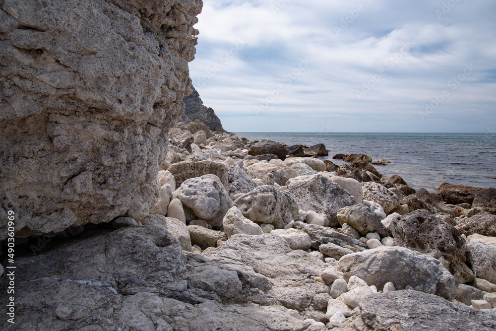 Stone mountains on the background of the sea landscape. Lime minerals. Geology near the ocean. Natural background. Stone mountains on the background of the sea landscape. Lime minerals. Geology near the ocean. Natural background.