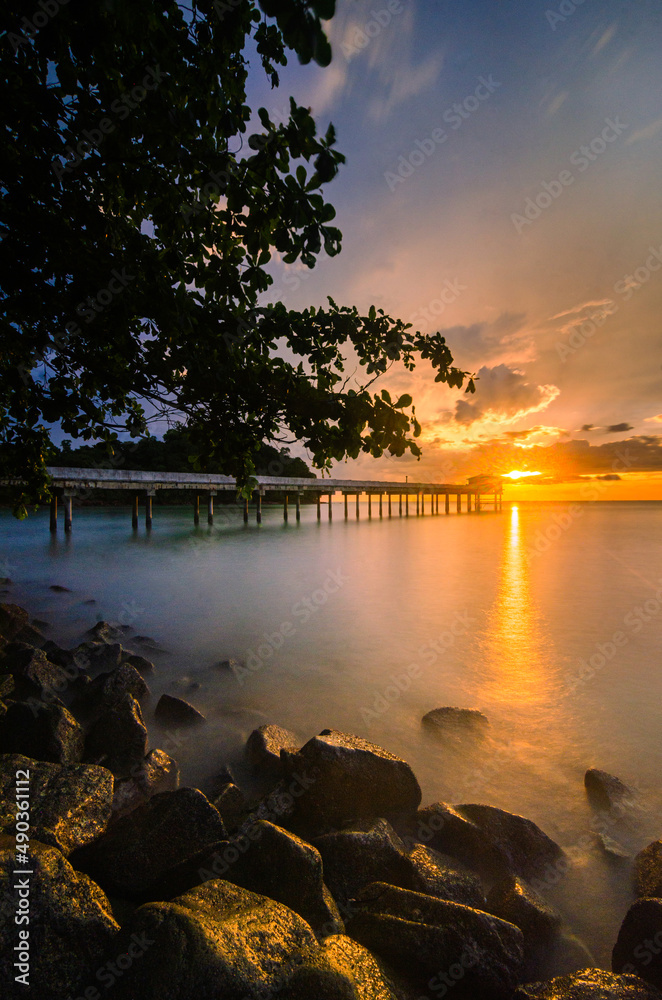 Beautiful scenery of the sunset with a view of a jetty

