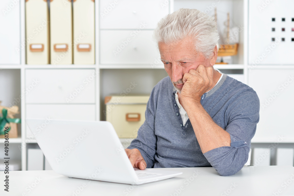 Portrait of emotional senior man using laptop Portrait of emotional senior man using laptop
