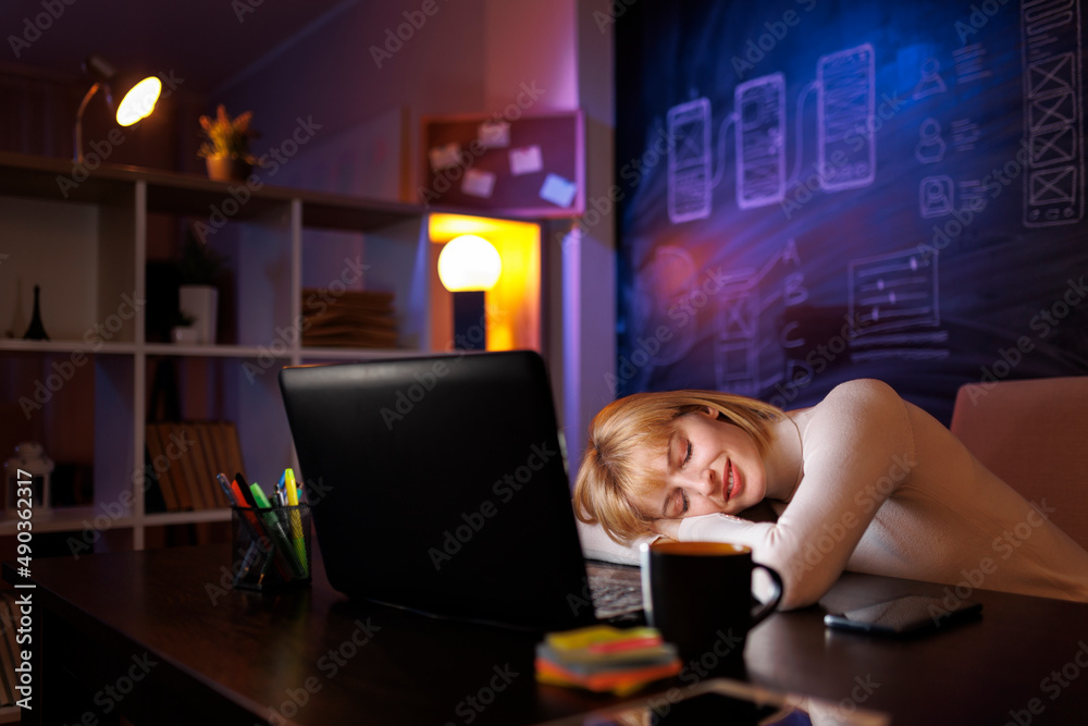 Woman sleeping at her desk while working late Woman sleeping at her desk while working late