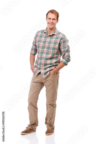 Enjoying the casual life. Portrait of a handsome young man standing with his hands in his pockets against a white background.