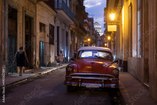 Amazing old american car on streets of Havana with Capitolio Building in background during night. Havana, Cuba. © danmir12