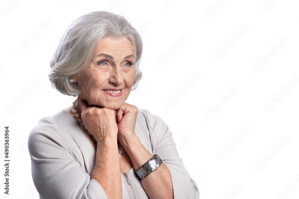Happy senior woman wearing light dress posing on white background Happy senior woman wearing light dress posing on white background