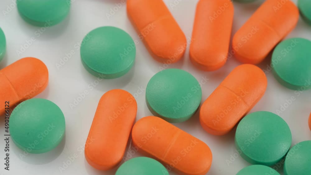 Slow Motion Shot of rotation Colorful Pills on wite Background. 4K Slow Motion Shot of rotation Colorful Pills on wite Background. 4K