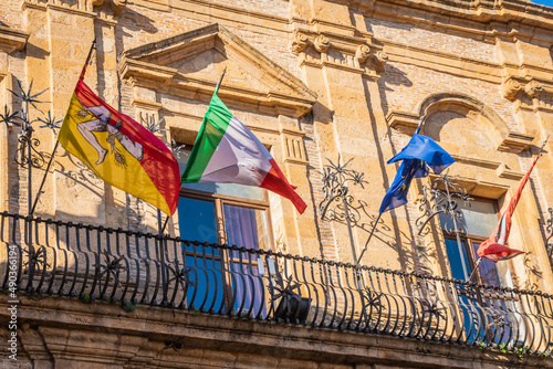 Waving Flags of Sicily, Italy, and Ue in the Ancient City Palace in Piazza Armerina, Sicily, Italy, Europe photo