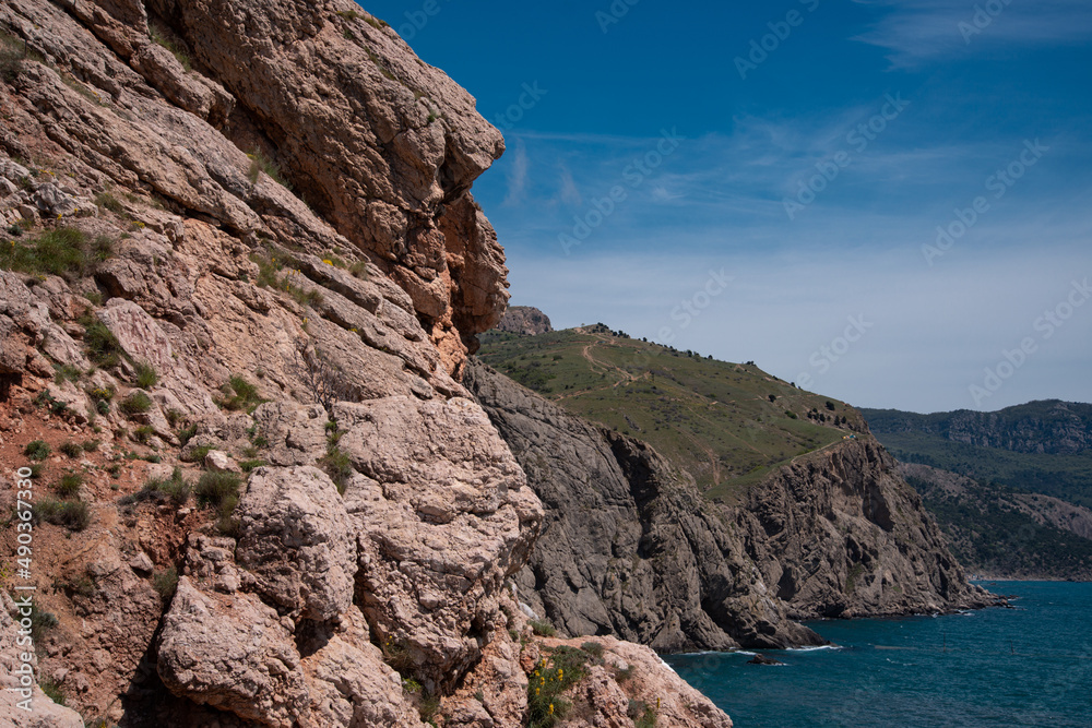 Rocky mountains on the background of the sea landscape. Coastline in summer. Rocky mountains on the background of the sea landscape. Coastline in summer.