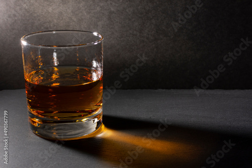 glass with whiskey on a dark background