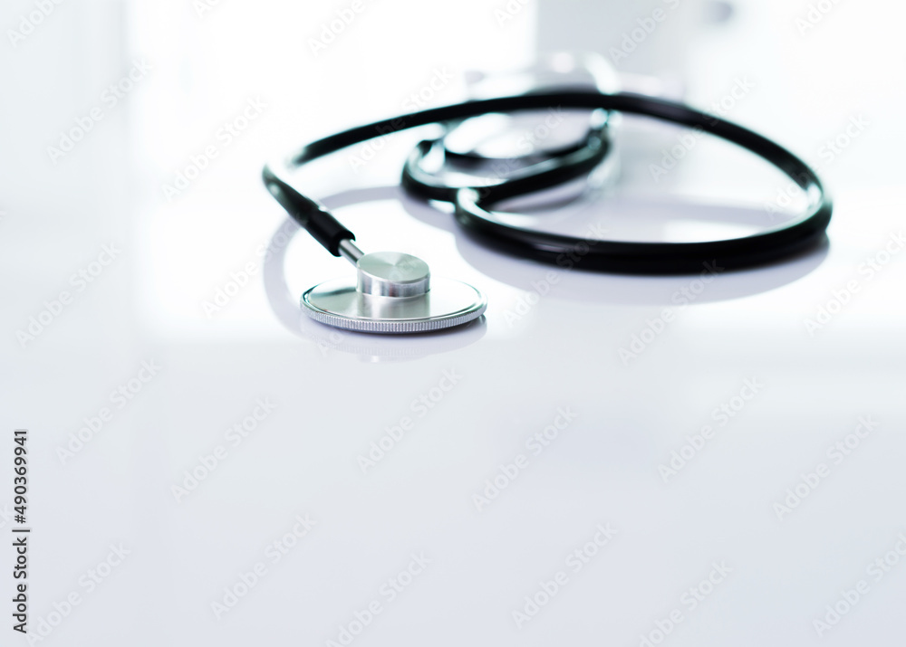 Single stethoscope on white table Single stethoscope on white table