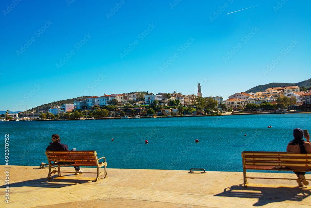 DATCA, TURKEY: View from the promenade on buildings and the sea in the town of Datca on a sunny day.