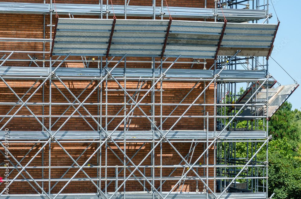buildings: scaffolding under construction, checked in every detail, for the workers' safety at work. All in galvanized steel: stone guards, uprights, joints and walkway.
