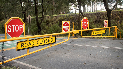No Entry Stop signs warning motorists that the road is closed and flooded. Youngs Crossing, Petrie, Queensland, Australia. 2022
