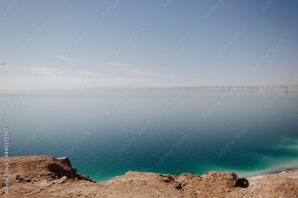 Dead Sea Jordan. Coast of the Dead Sea on a clear sunny day. Turquoise color of water.