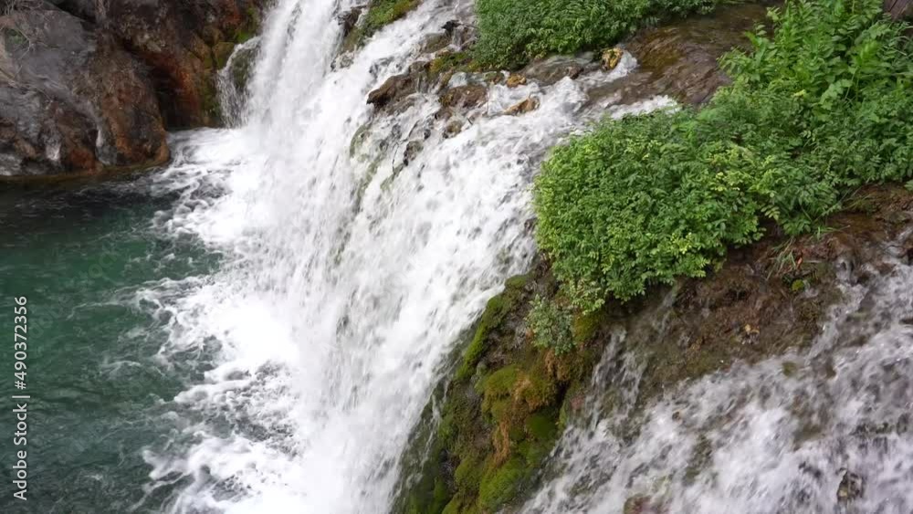 abundant fresh water flows into the river in a small waterfall after the melting ice in the mountains abundant fresh water flows into the river in a small waterfall after the melting ice in the mountains