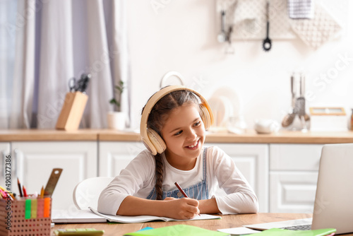 Little girl in headphones s...