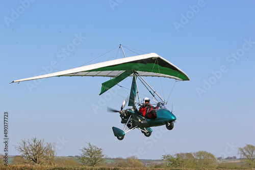 Canvas-taulu Ultralight airplane flying in a blue sky
