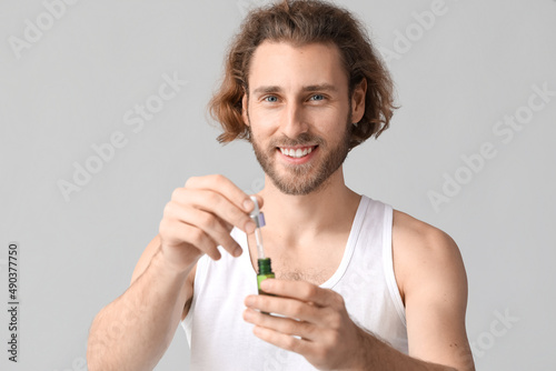Young man with serum for sk...