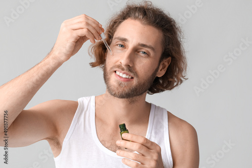 Young man with serum for sk...