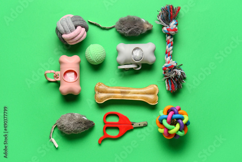 Different pet care accessories on green background