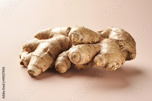 Ginger root. Fresh ginger root on a beige background. Vitamins. Virus-protecting products. Top view. Free space for your text.