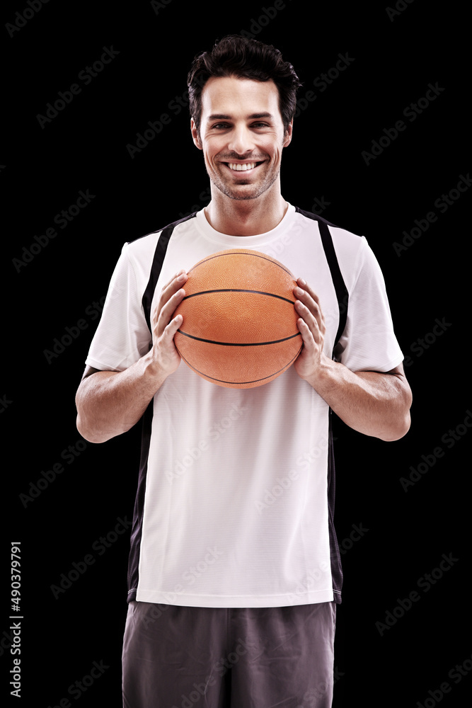 Game on. Studio shot of a handsome young basketball player isolated on black.