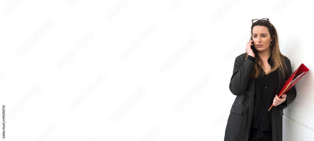 Portrait of young woman with eyeglasses using mobile phone on white wall background Portrait of young woman with eyeglasses using mobile phone on white wall background