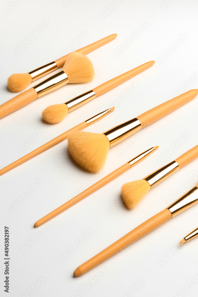 Set of yellow makeup brushes on white background Set of yellow makeup brushes on white background