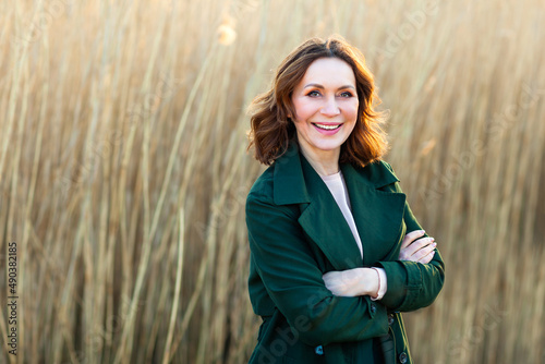 portrait of middle aged woman posing at the park