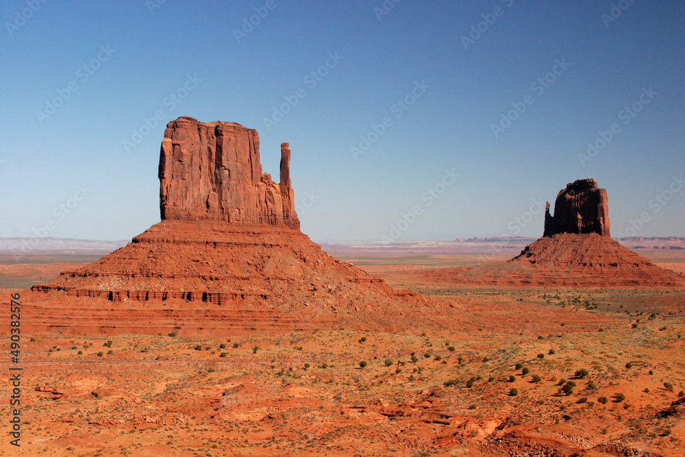 Rock formations on an arid landscape, East Mitten and Merrick Buttes, Monument Valley, Arizona, USA Rock formations on an arid landscape, East Mitten and Merrick Buttes, Monument Valley, Arizona, USA