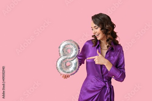 Smiling young woman with ba...