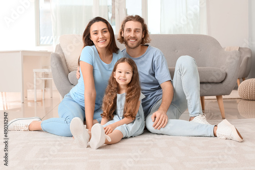 Young family sitting on sof...