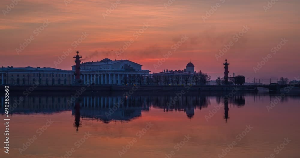 Timelapse of Old Stock Exchange Building and Rostral columns in dusk, water area of Neva River at sunset, water mirror, magic reflections, Birzhevoy and Palace bridge