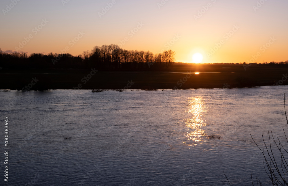 clear sky, golden sunset,  river,  spring evening near Lielupe river Latvia	