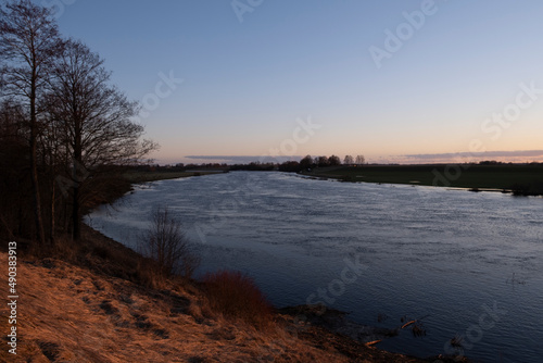 clear sky  golden sunset  winding river  purple clouds  spring evening near Lielupe river Latvia