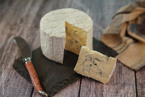 Portion of delicious bleu de Bresse cheese on a rustic background