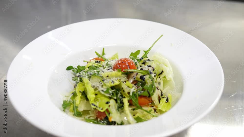 Grated cheese appetizingly sprinkled on a fresh salad. Healthy food. Vegetarian diet. Slow motion Grated cheese appetizingly sprinkled on a fresh salad. Healthy food. Vegetarian diet. Slow motion