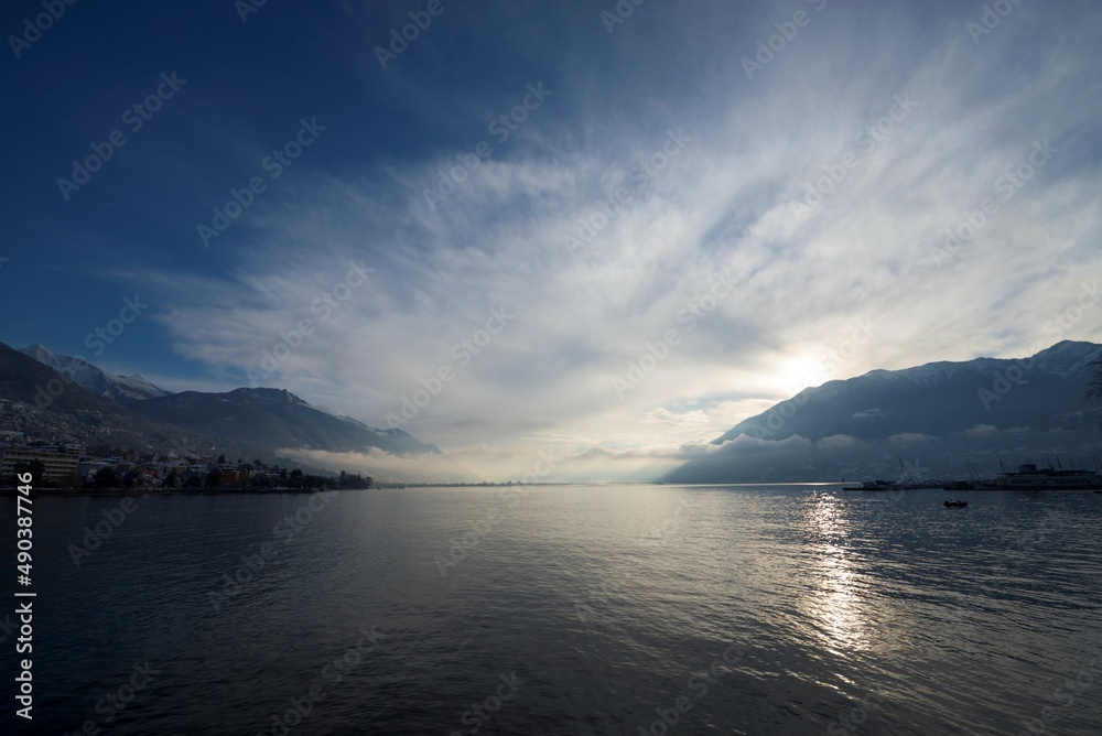Alpine Lake Maggiore with Clouds and Sunlight in Locarno, Switzerland. Alpine Lake Maggiore with Clouds and Sunlight in Locarno, Switzerland.
