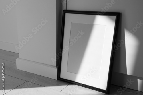 Minimalist black frame mockup on white background with shadow in interior