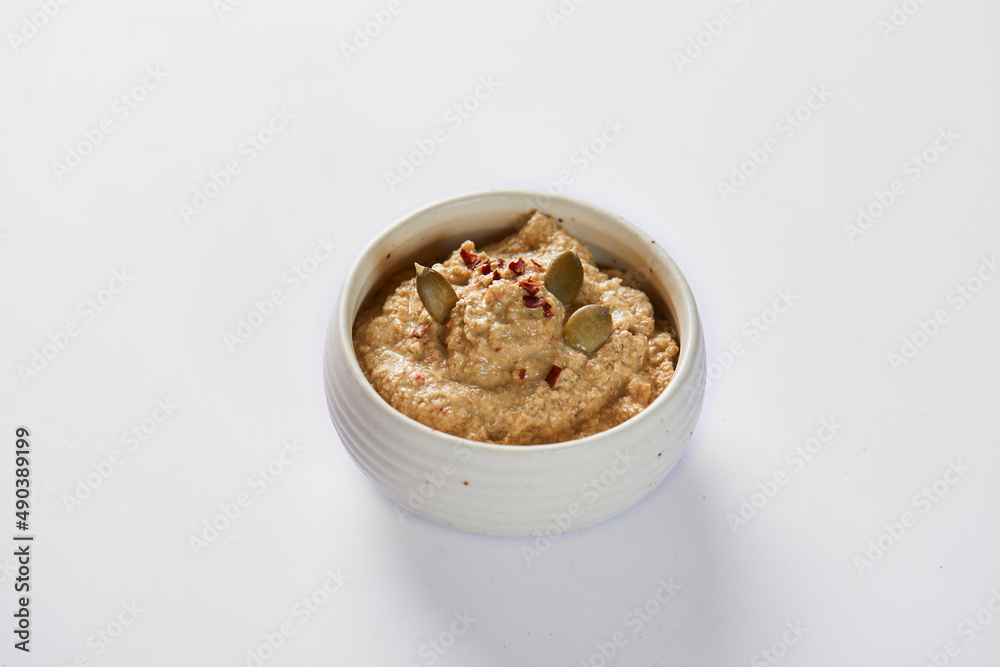 Ají de pepa is a traditional ecuadorian hot sauce made of squash seeds. It’s on a white background Ají de pepa is a traditional ecuadorian hot sauce made of squash seeds. It’s on a white background