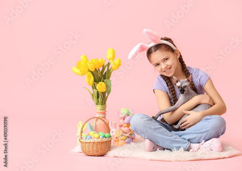 Little girl with Sphynx cat...