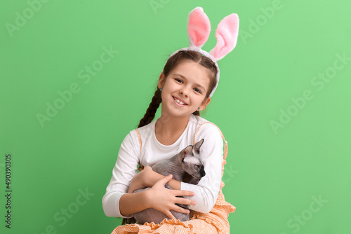 Little girl in bunny ears w...