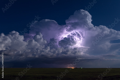 Thunderstorm illuminated by lightning photo