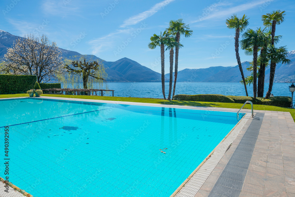 Swimming Pool and Alpine Lake Maggiore with Mountain in Ascona, Switzerland. Swimming Pool and Alpine Lake Maggiore with Mountain in Ascona, Switzerland.