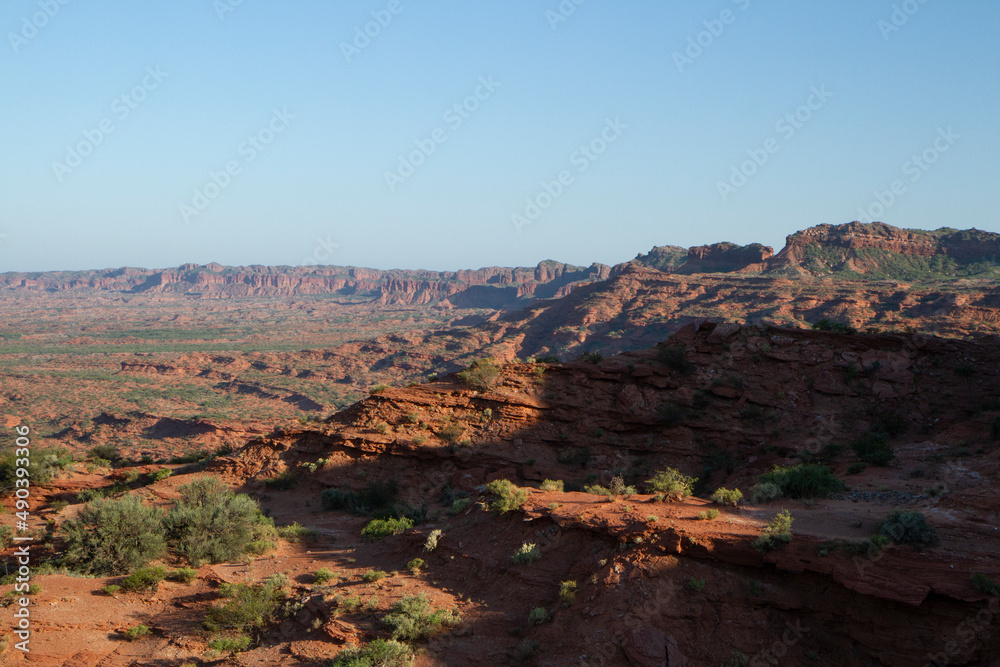 Prehistoric cliffs in Sierra de las Quijadas National Park. Arid desert landscape. Red sandstone, hills, canyon and valley view. Prehistoric cliffs in Sierra de las Quijadas National Park. Arid desert landscape. Red sandstone, hills, canyon and valley view.
