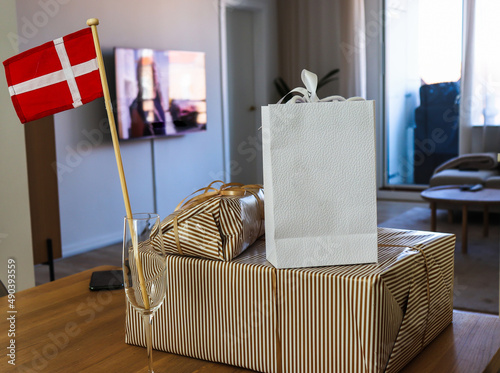 Packages with birthday gifts and the danish flag in the room of the apartment. High quality photo