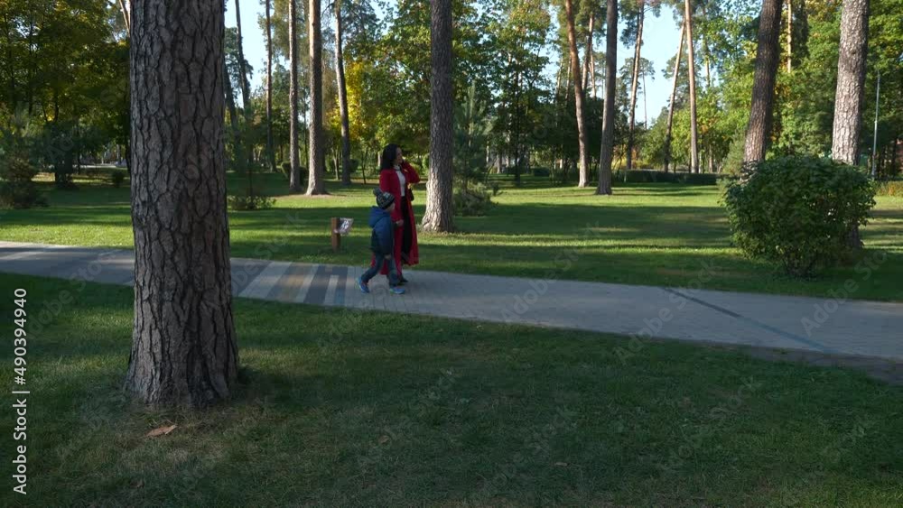 Mother and Son Walk in City Park. Woman Rest With Child Kid Boy. Sunny Day. 2x Slow motion 60fps 4K Mother and Son Walk in City Park. Woman Rest With Child Kid Boy. Sunny Day. 2x Slow motion 60fps 4K
