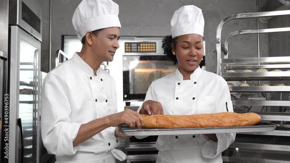 Vidéo Stock A senior Asian male baker giving thumbs up to a young