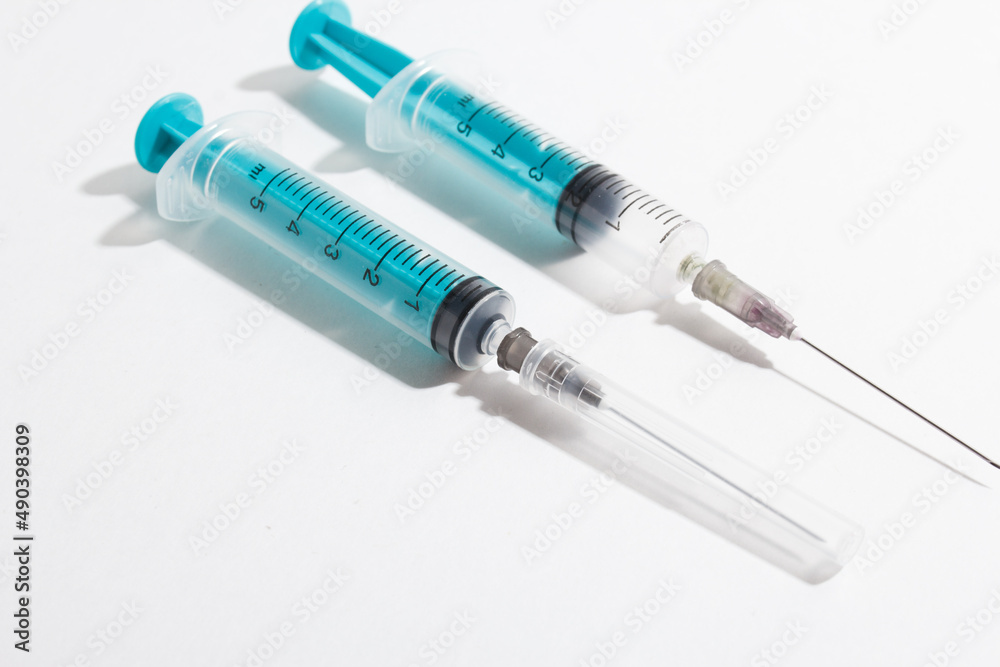 Medical syringe on a white background. A syringe for injection. The concept of health and beauty Medical syringe on a white background. A syringe for injection. The concept of health and beauty