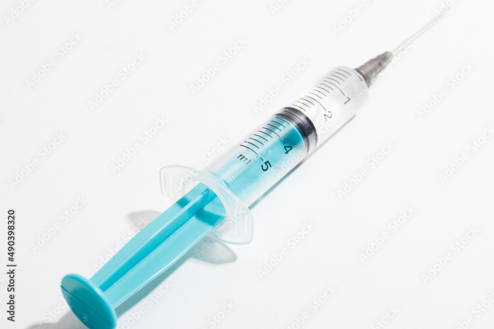 Medical syringe on a white background. A syringe for injection. The concept of health and beauty Medical syringe on a white background. A syringe for injection. The concept of health and beauty
